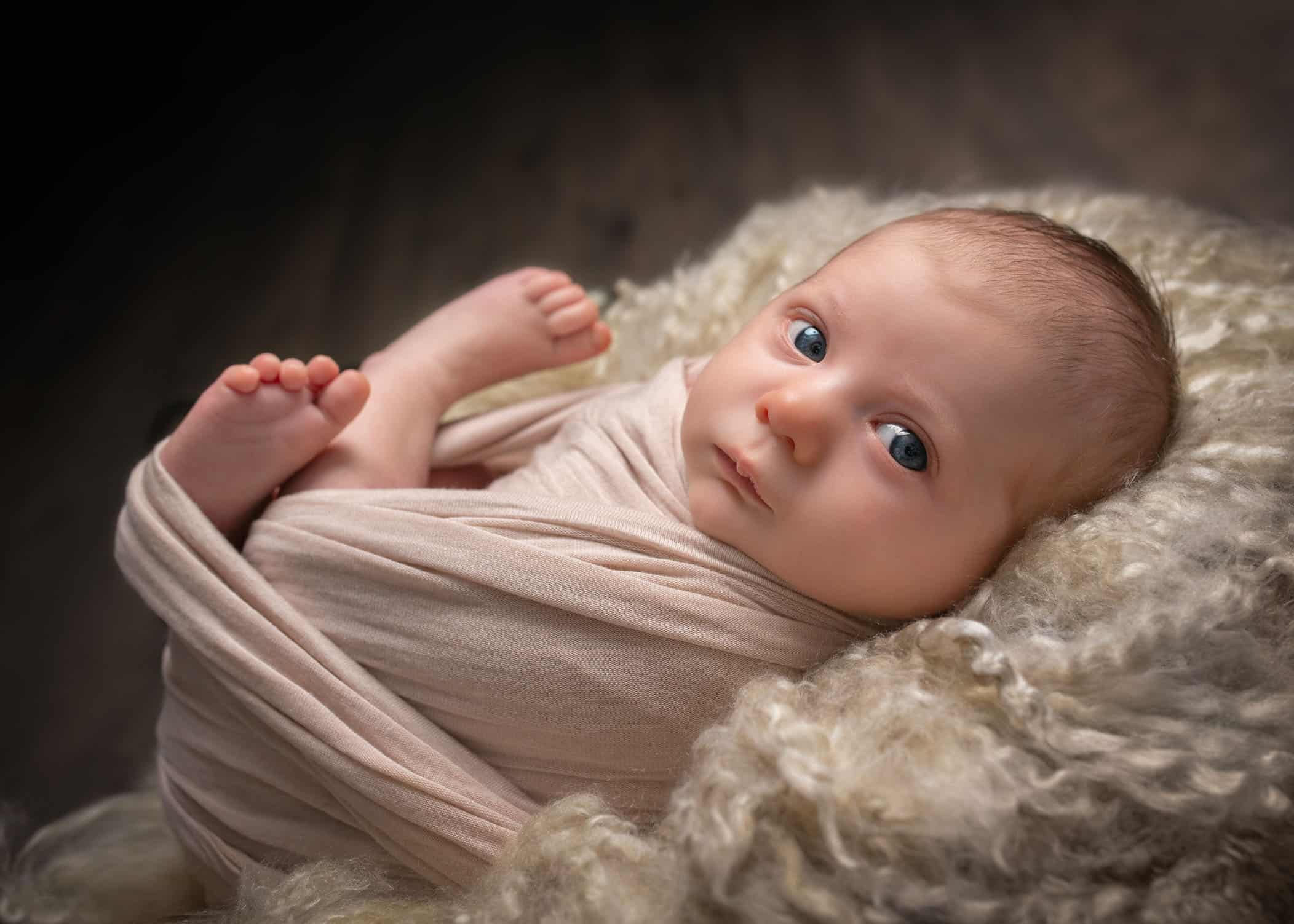 Newborn baby girl looking at the camera