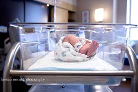 hospital newborn photographer baby in clear bassinett