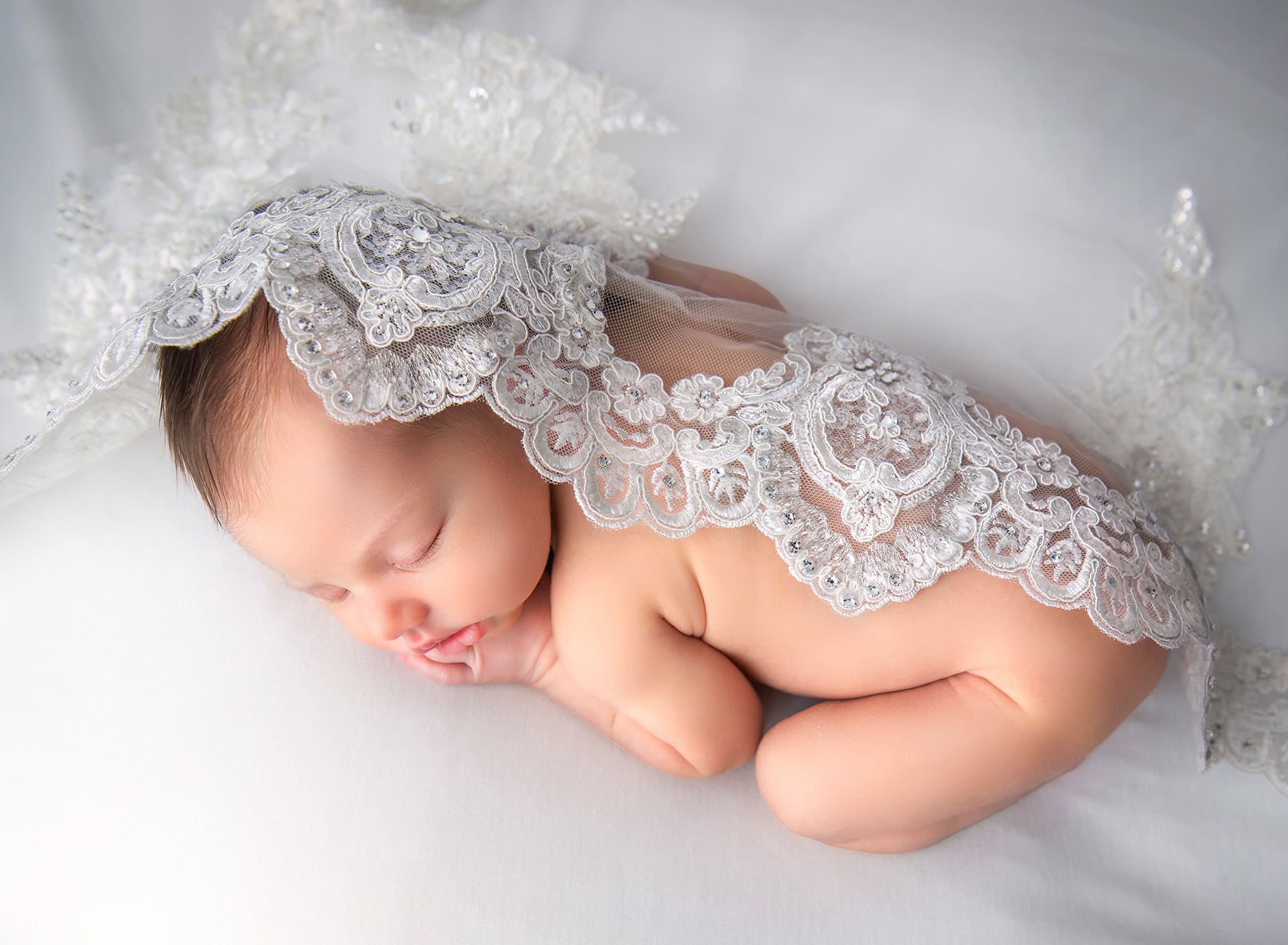 maternity and newborn photography Brooklyn covered with Mom’s lace veil while she sleeps.