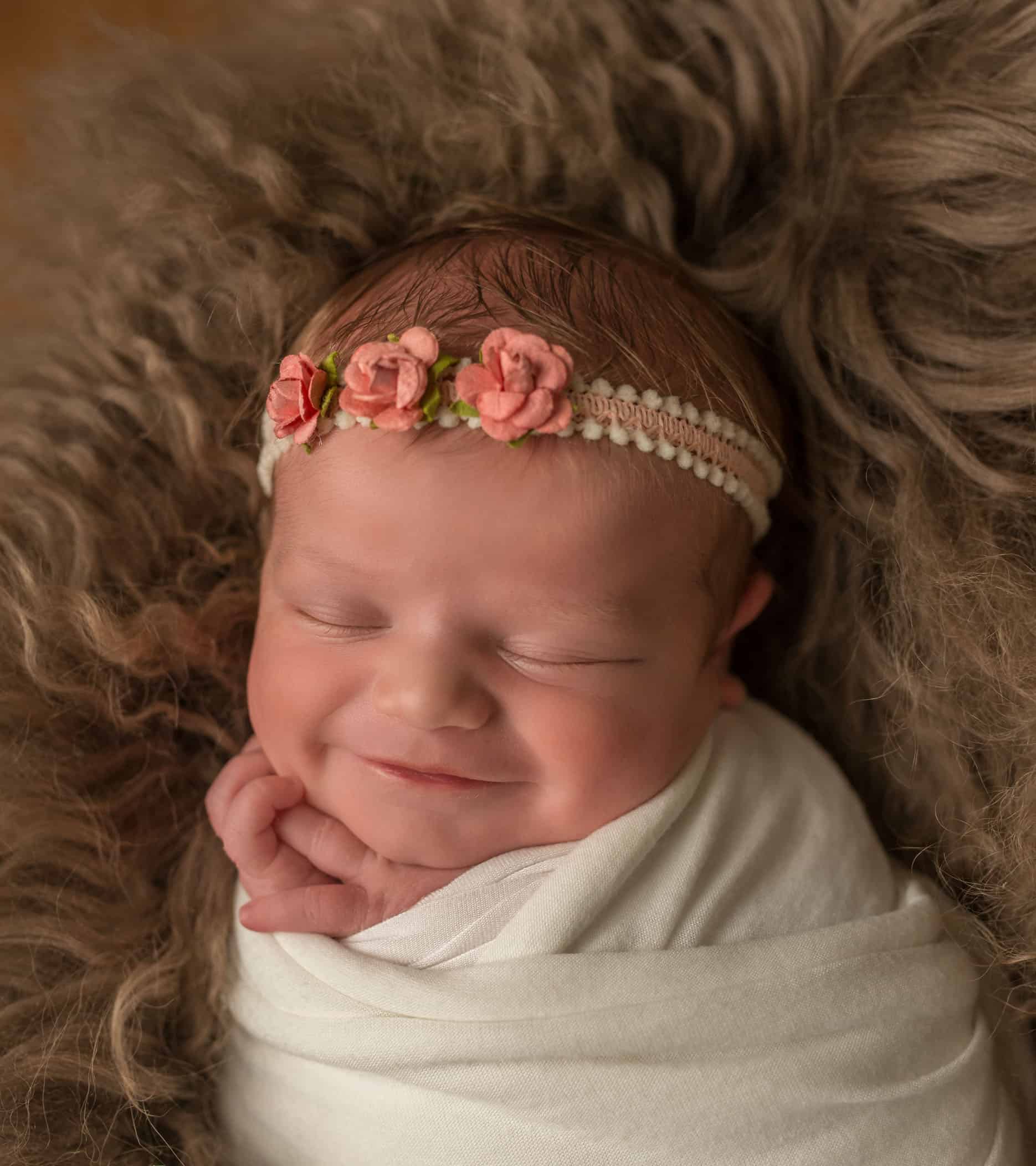 newborn baby girl smiling