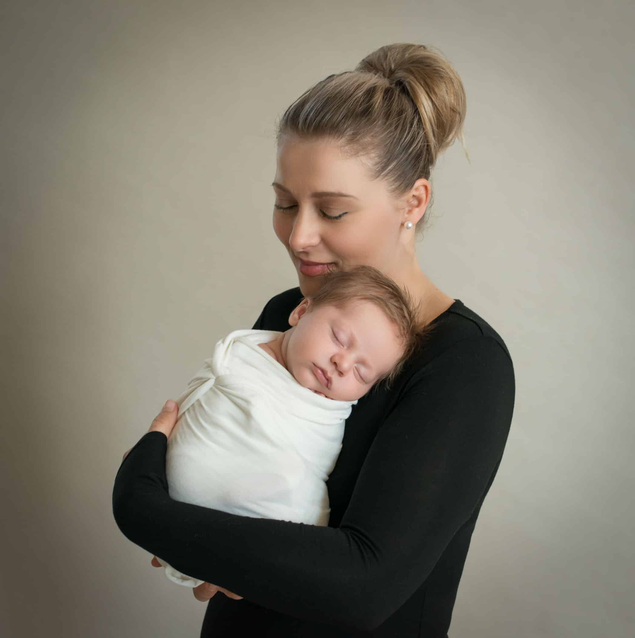 Mom holding newborn baby boy in her arms