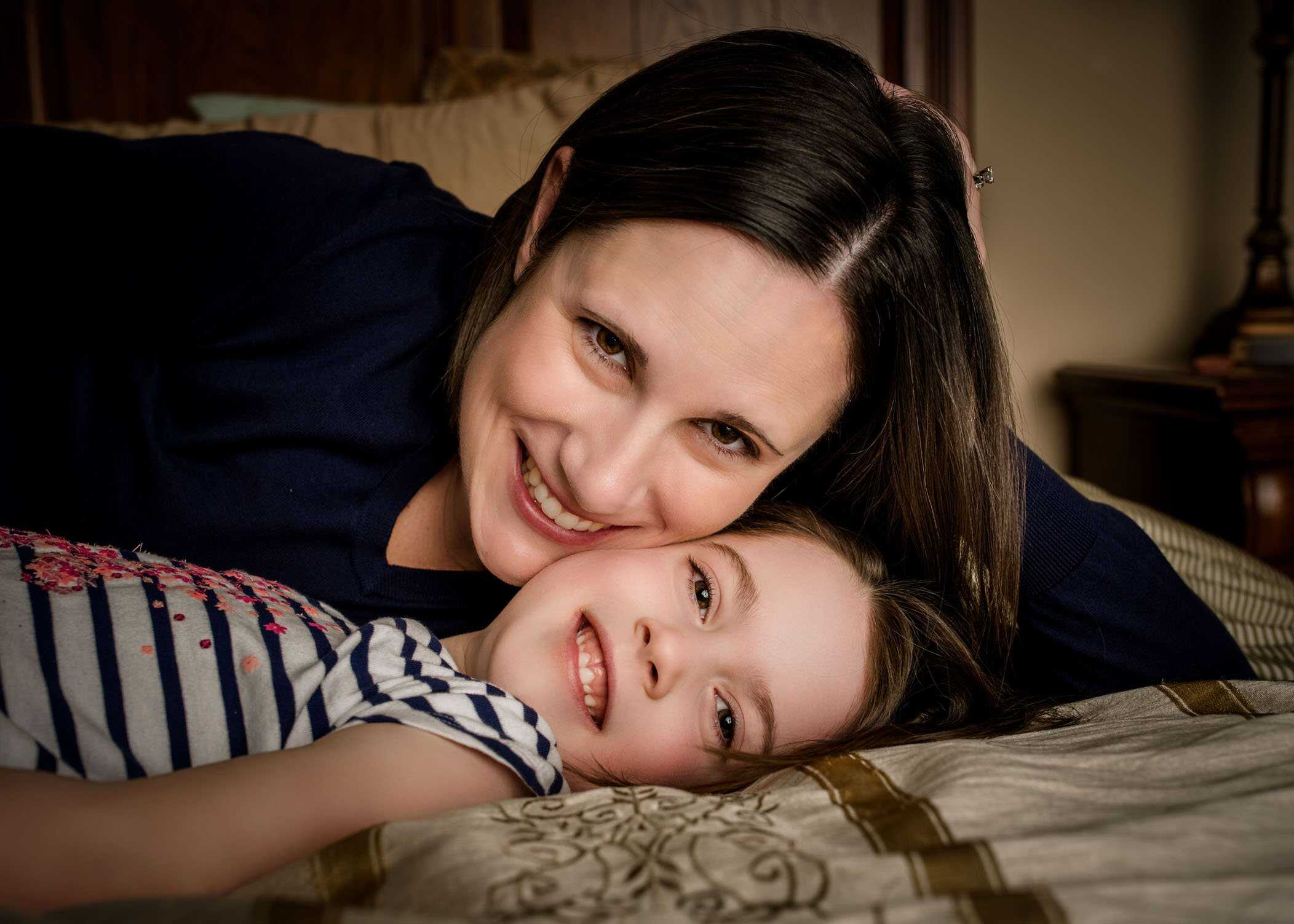 Mom and 5 year old daughter cheek to cheek