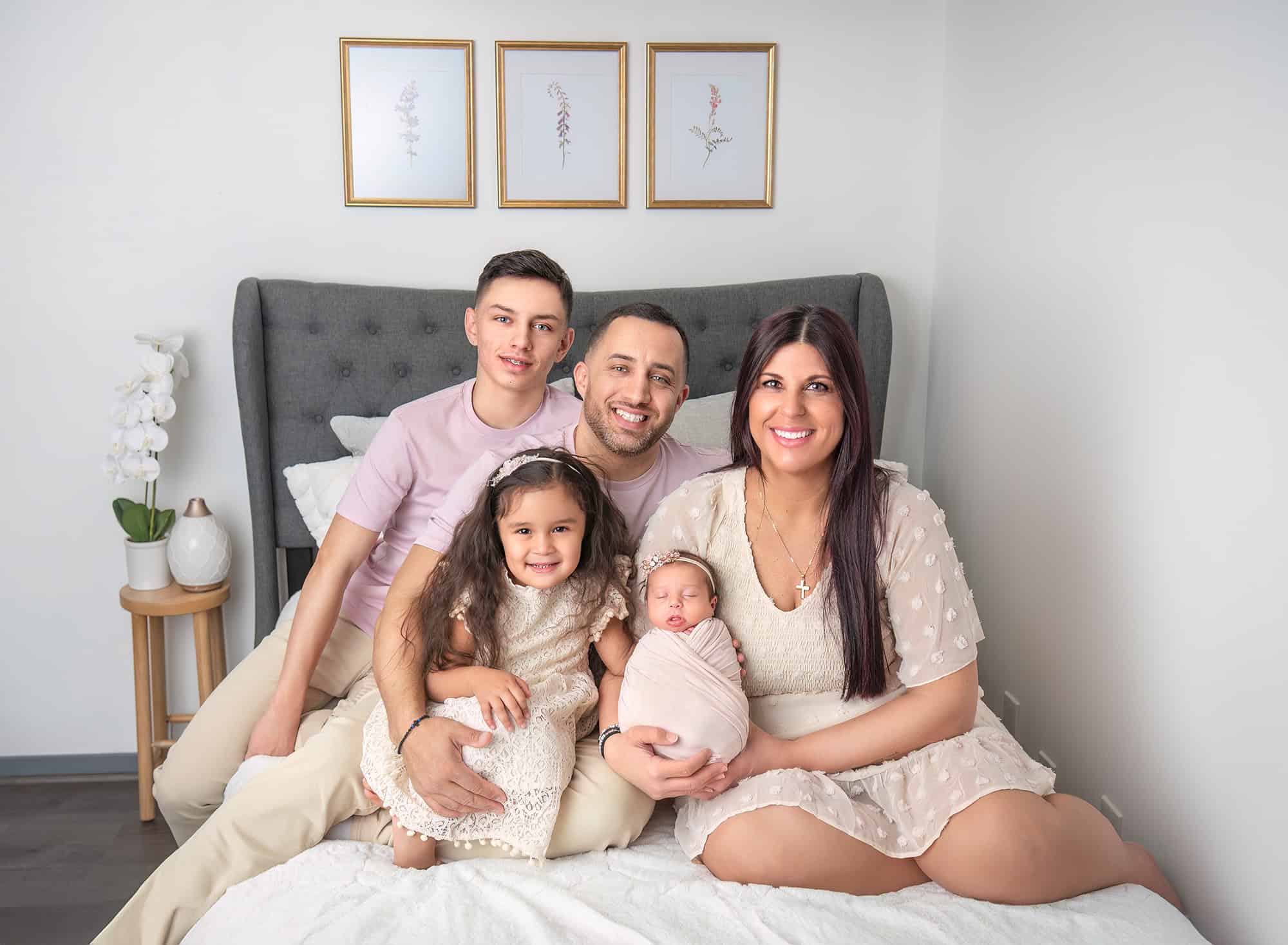 Newborn Maternity Photographer lifestyle portrait of family of five with their new baby sister.