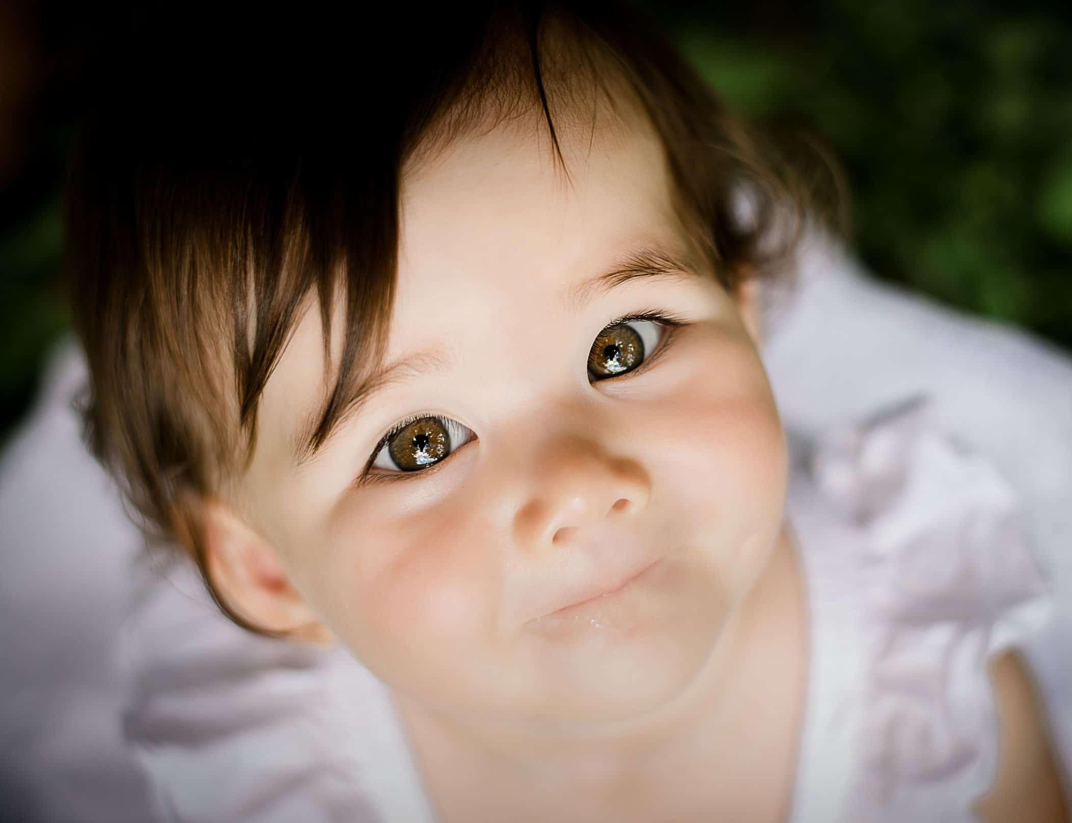 one year old baby girl pic staring up at camera with reflection in her eyes One Big Happy Photo
